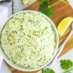 a white bowl of Instant Pot cilantro rice on a wooden board