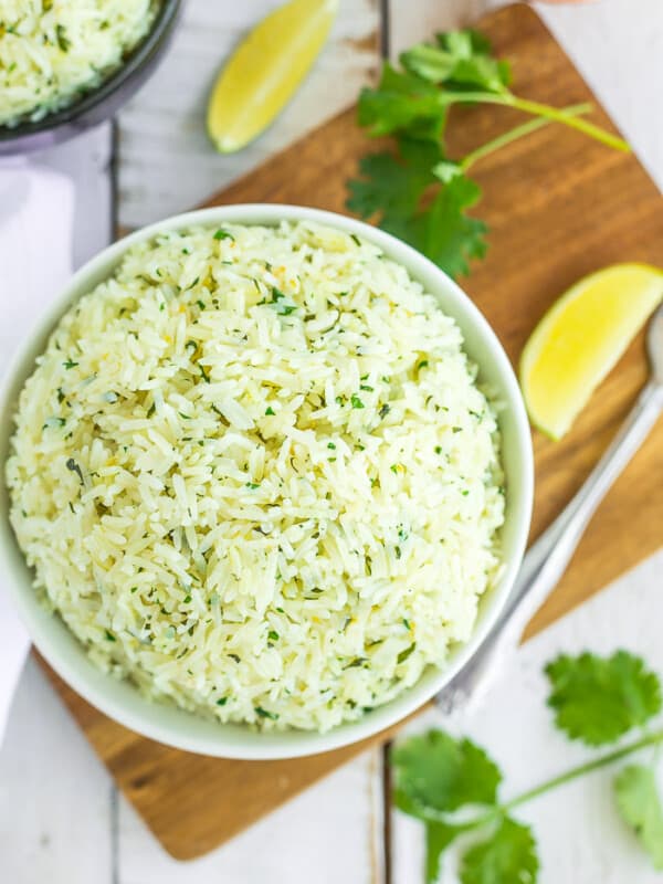 a white bowl of Instant Pot cilantro rice on a wooden board