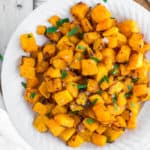 crispy air fryer butternut squash on a white plate