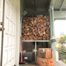 a stack of firewood on a porch