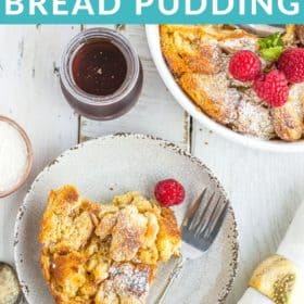 a white dish with eggnog bread pudding topped with raspberries