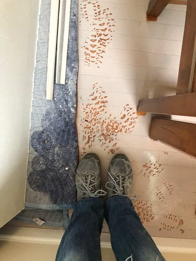 feet standing on a dusty floor