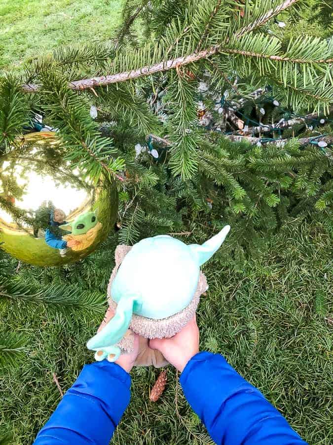 baby yoda's reflection in a christmas ball