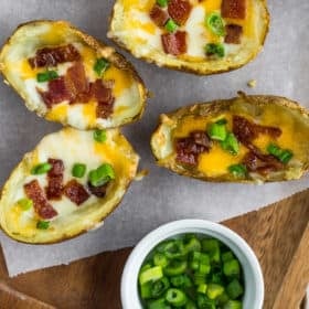 crispy potato skins topped with green onions and bacon