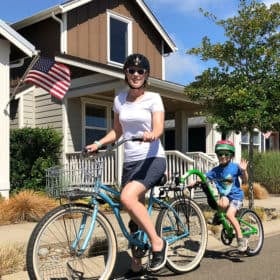 A mom and her son on a Burley trailercycle
