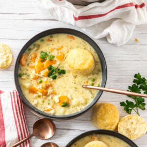 2 bowls of chicken pot pie with biscuits and herbs