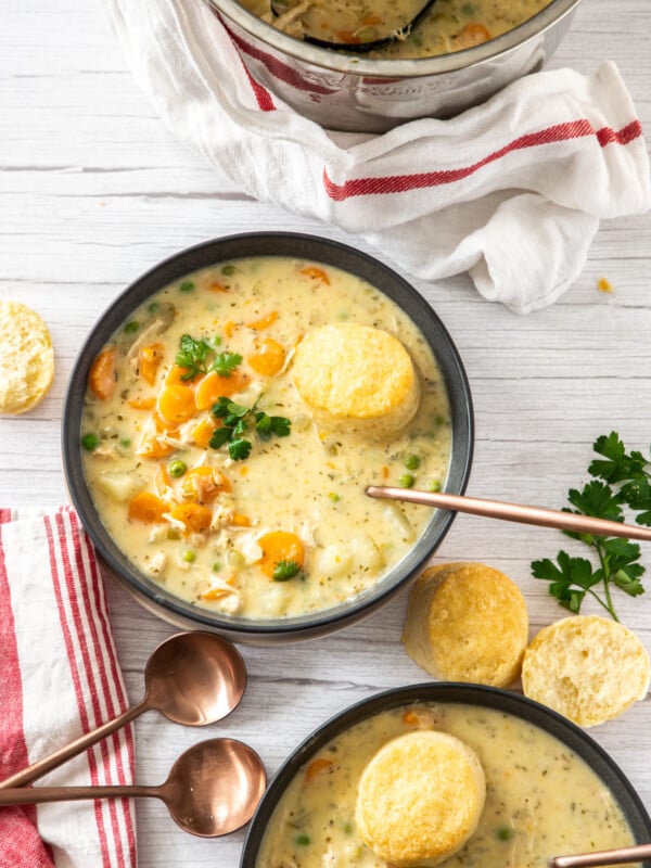 2 bowls of chicken pot pie with biscuits and herbs