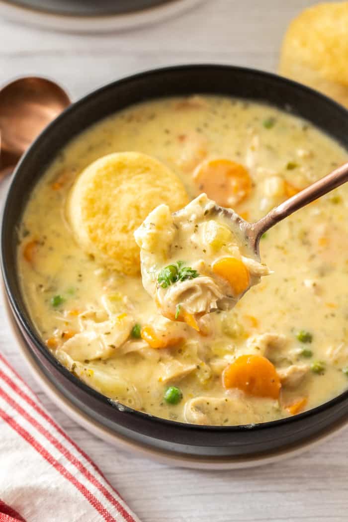 a black bowl with a spoon full of Instant Pot chicken pot pie