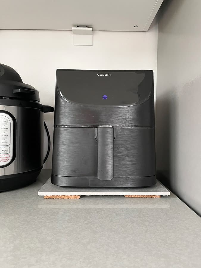 an air fryer on a tile on a counter