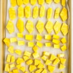 chunks of frozen pineapple on a baking sheet