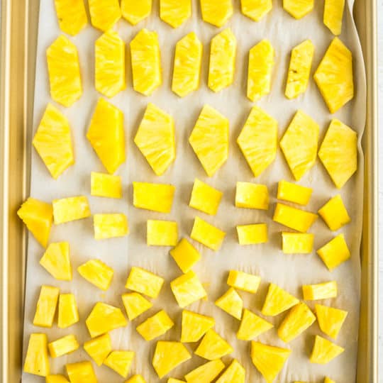 chunks of frozen pineapple on a baking sheet
