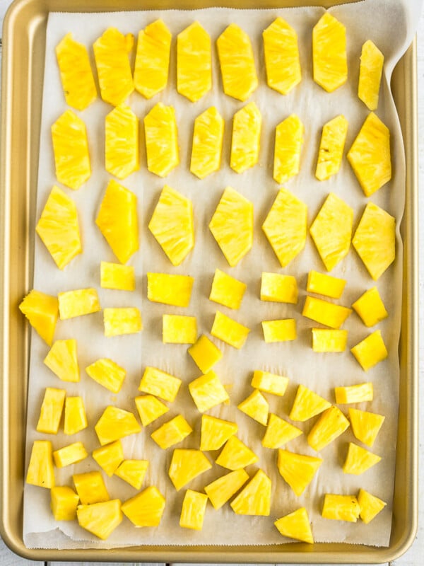 chunks of frozen pineapple on a baking sheet