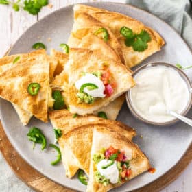 A plate of air fryer quesadillas topped with cilantro