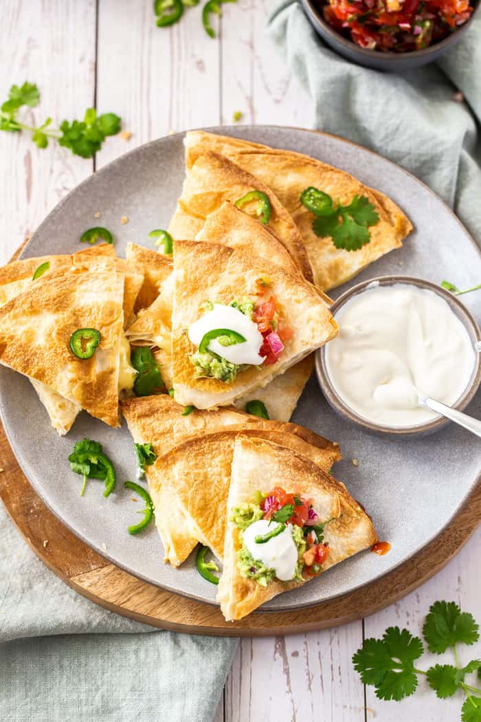 A plate of air fryer quesadillas topped with cilantro