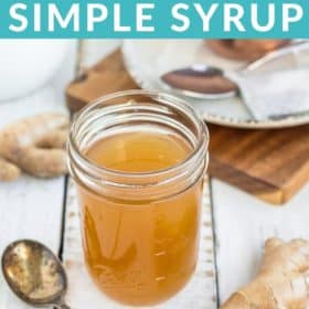 a jar of honey ginger syrup with a spoon