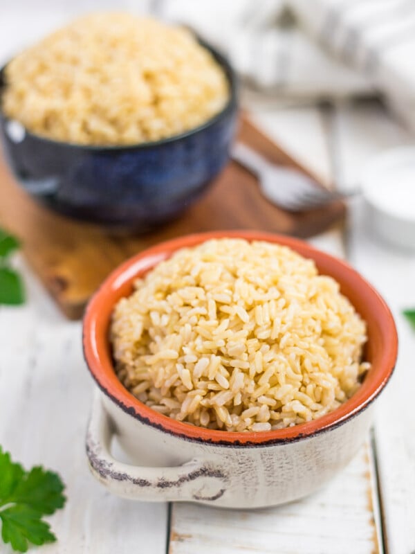 Two bowls of Instant Pot brown rice on a white board