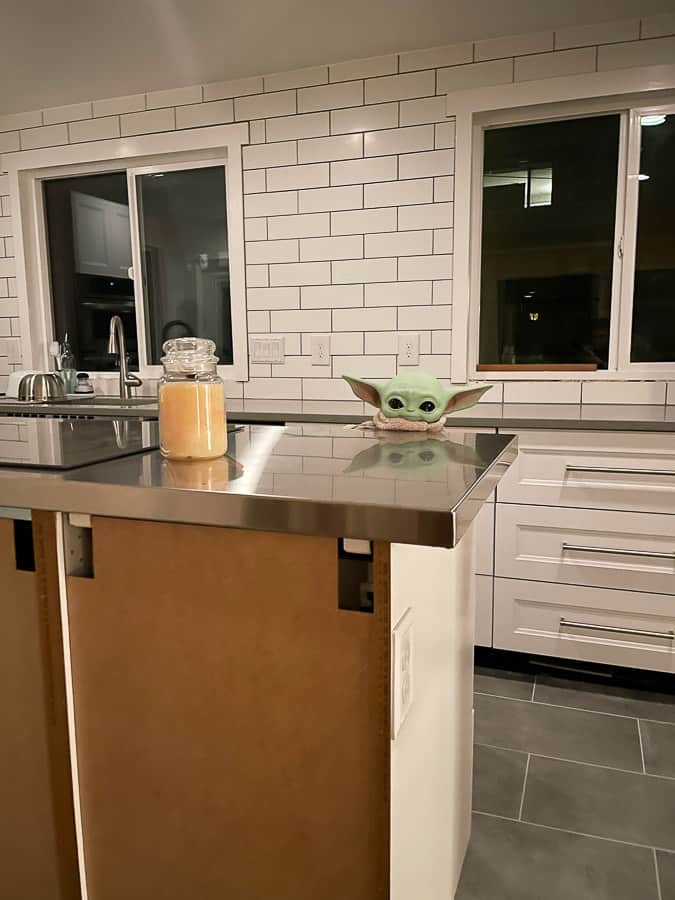 baby yoda poking up over a kitchen island