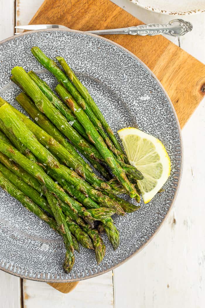 roasted frozen asparagus on a grey plate
