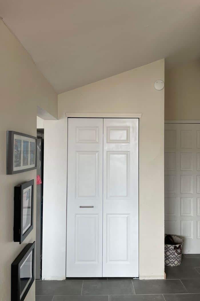 a pantry with white doors