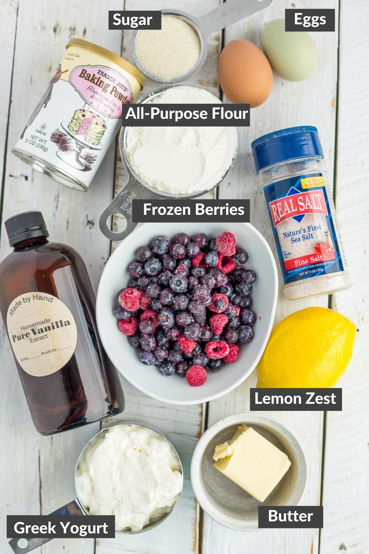 a lemon, butter, salt, and other ingredients on a wooden board.