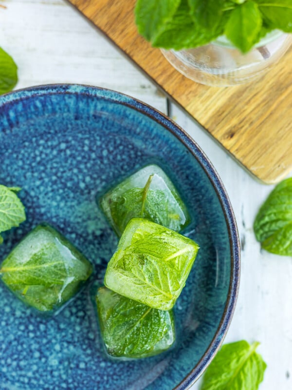 frozen cubes on mint on a blue plate