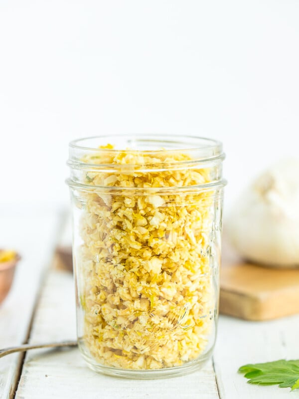 a canning jar of dried garlic on a white board