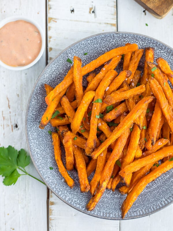 frozen sweet potato fries in an air fryer on a plate