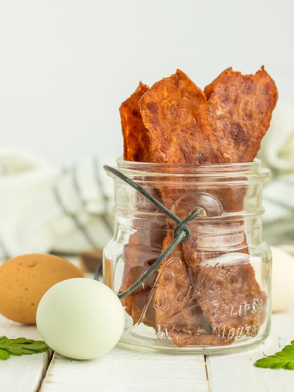 a canning jar with turkey bacon standing up in it