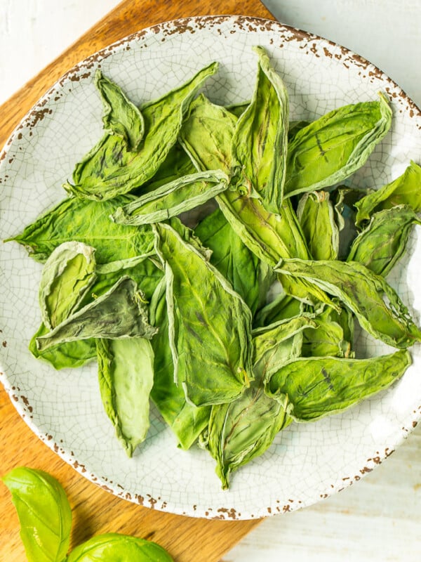 a plate of dehydrated basil leaves