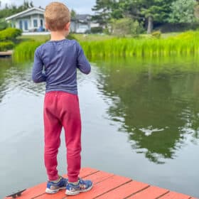 a boy fishing off a dock