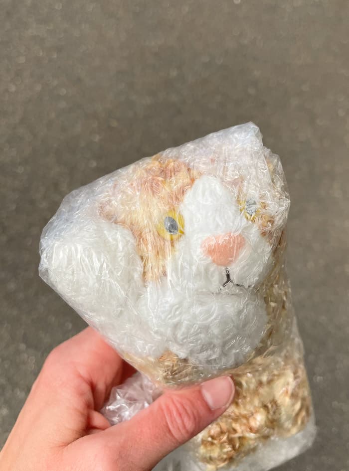 a stuffed cat toy wrapped in bubble wrap