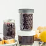 jar of blueberry freezer jam on a white board