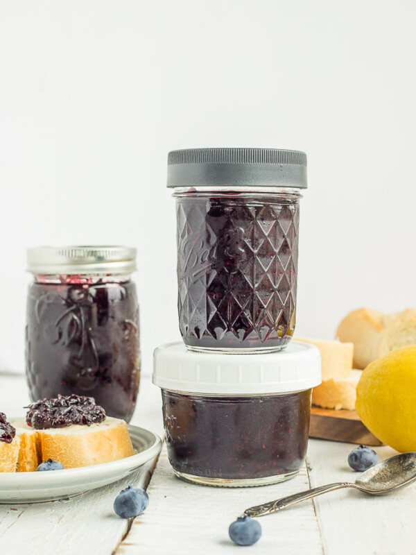 jar of blueberry freezer jam on a white board