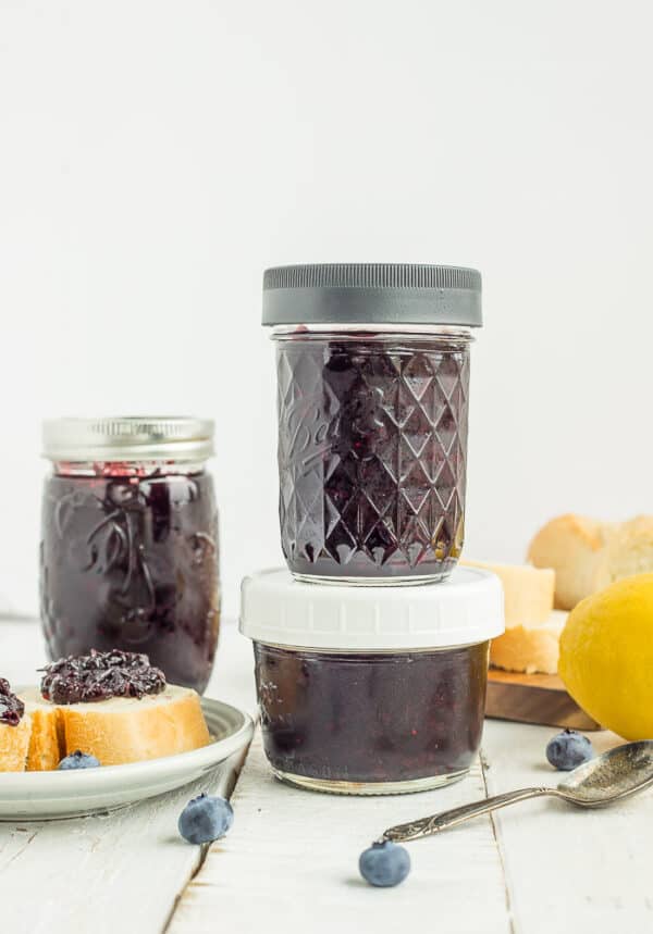 jar of blueberry freezer jam on a white board
