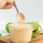A spoon of southwest sauce over a glass jar