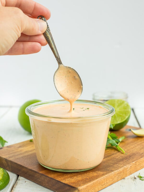 A spoon of southwest sauce over a glass jar