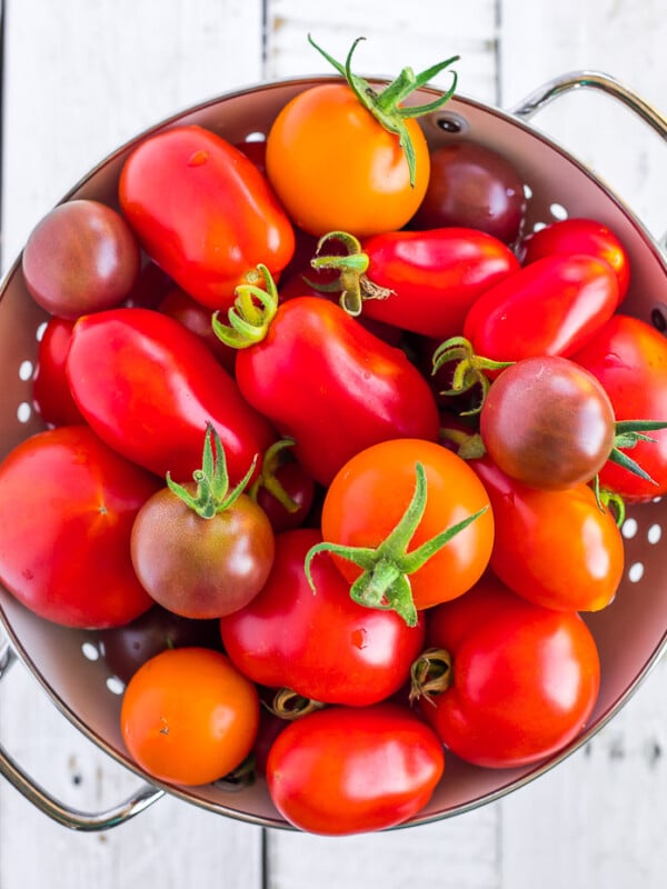 a white strainer full of tomatoes