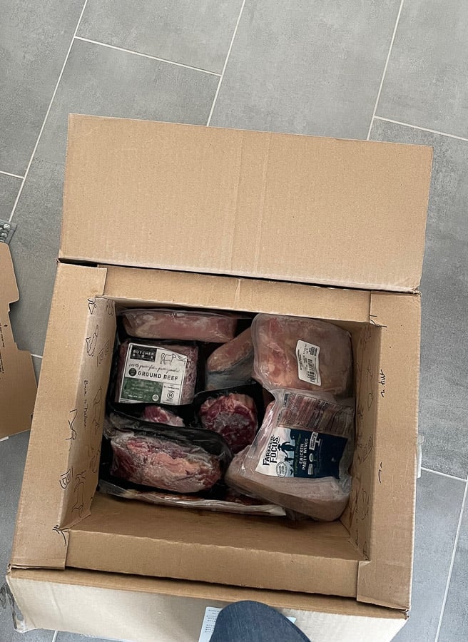 a cardboard box full of frozen meat from butcher box