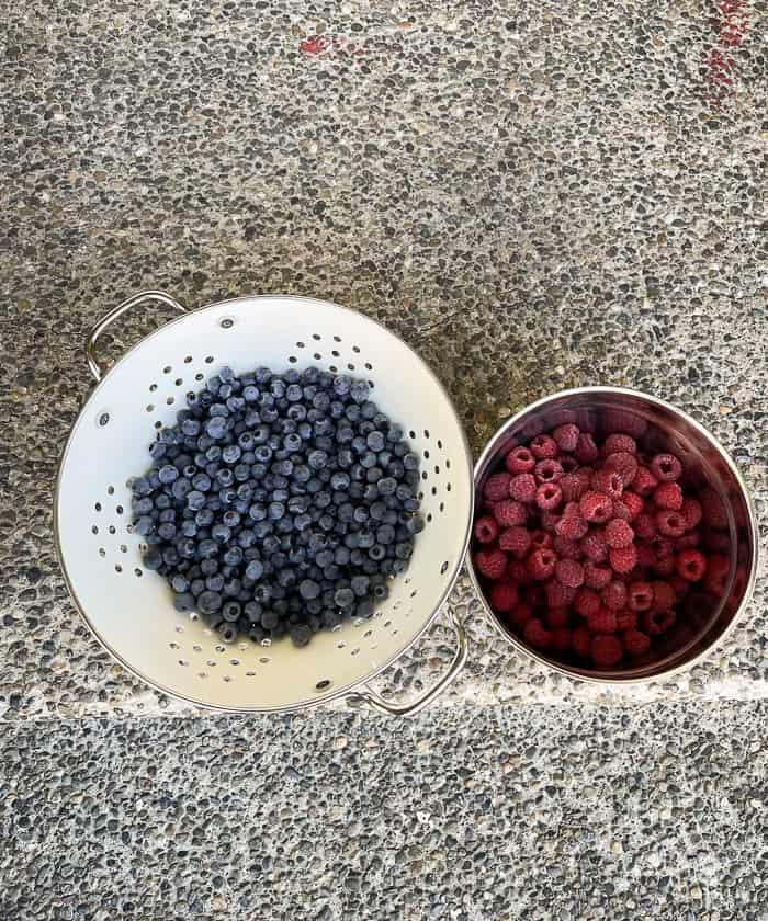 bowls of berries on a front porch