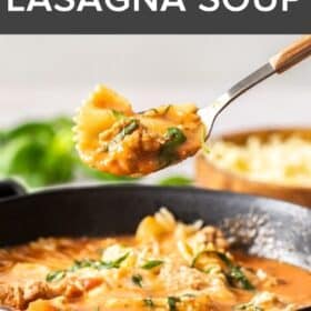 a spoon lifting a bite of Instant Pot Lasagna Soup over a dark grey bowl