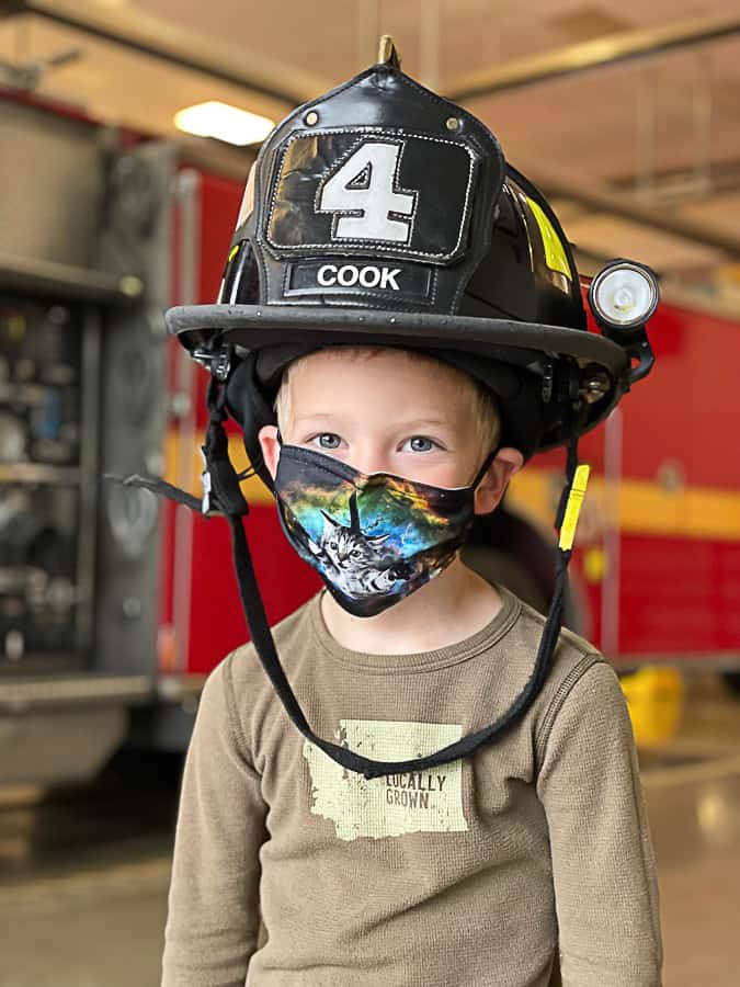 a boy in a firefighter helmet