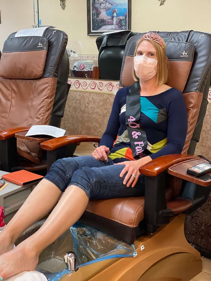 a woman in a crown in a pedicure chair