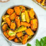 rainbow carrots in a white bowl with parsley