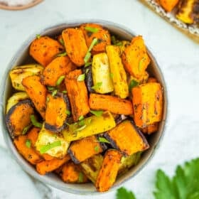 rainbow carrots in a white bowl with parsley