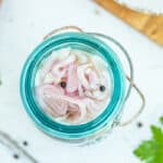 sliced shallots in a blue jar