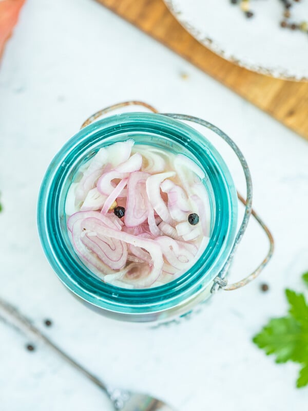 sliced shallots in a blue jar