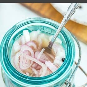 a blue jar with pickled shallots