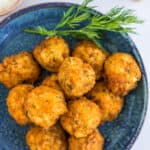 air fryer crab cakes on a blue dish with dill