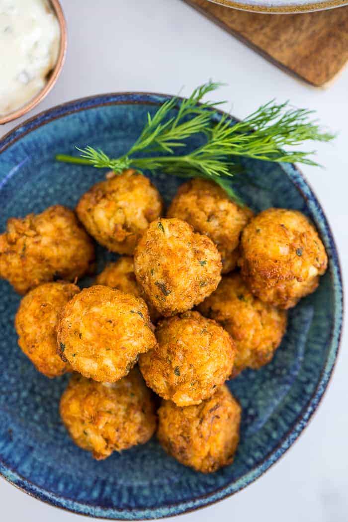 air fryer crab cakes on a blue dish with dill