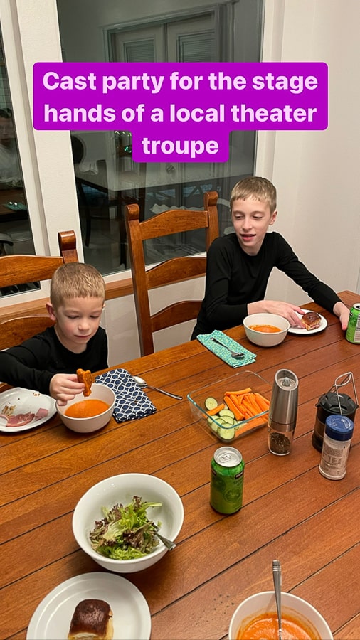 2 kids wearing all black outfits eating dinner